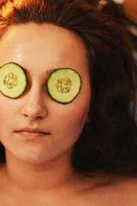 woman with cucumbers on her eyes at the spa